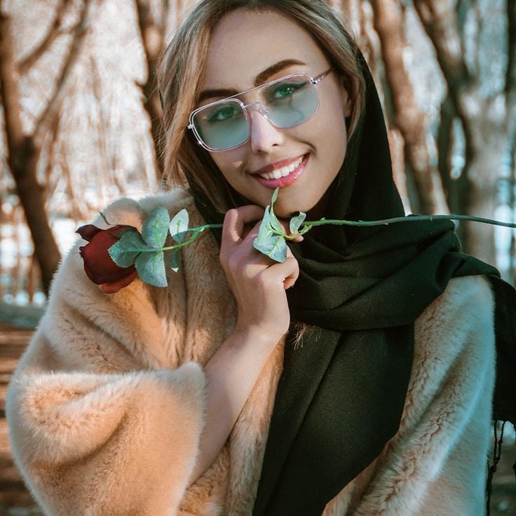 Avery Chen, Lead Design Curator at HarborPlateau, reviewing corporate floral arrangements